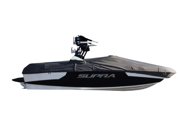 A black and white Supra boat with a protective cover over it.