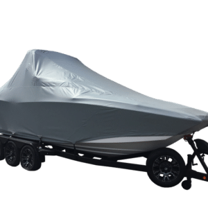 A boat covered with a gray tarp is sitting on a trailer with four wheels against a plain white background.