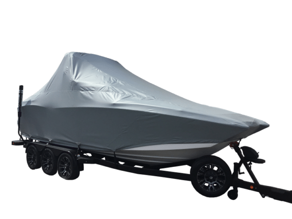 A boat covered with a gray tarp is sitting on a trailer with four wheels against a plain white background.