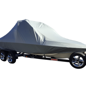 A boat covered with a gray tarp on a trailer.