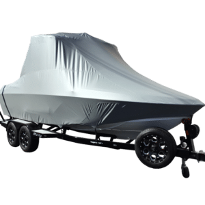 A boat covered with a gray tarp on a black trailer with four wheels.